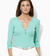 A deep split neckline finished with silver-toned buttons lends modern allure to a classic striped Henley in soft ribbed cotton.