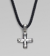 A handsomely crafted sterling silver cross pendant hangs from a finely braided leather necklace. Adjustable necklace, 18-20 Imported