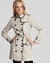 Check print trim binds the seams of this iconic Burberry trench coat--an updated take on a timeless staple.