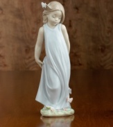 A little girl in a flowing gown crowned with a butterlfy in her hair and on her dress. Porcelain. Measures 8.5 x 3.25.