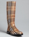 Burberry puts high polish on these glossy rain boots in signature Haymarket check plaid: Instantly classic.