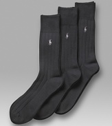 Polo Ralph Lauren 3-pack solid ribbed socks. Solid cotton ribbed sock with polo player embroidery. Banded cuffs.