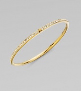 EXCLUSIVELY AT SAKS. A row of shimmering channel-set crystals within a glowing, golden hinged bangle. Crystal 18k goldplated Diameter, about 2¼ Push-lock clasp Imported