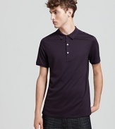 Check print accents the inner placket of Burberry Brit's classic polo shirt.