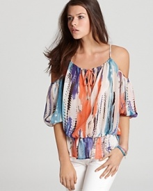 A billowy silhouette, cutout shoulders and abstract print infuse this eclectic GUESS top with carefree summer style. A billowy silhouette, cutout shoulders and abstract print infuse this eclectic GUESS top with carefree summer style.