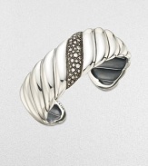 From the Cable Wrap Collection. This iconic style features a center band of pavé diamonds. Diamonds, .57 tcw Sterling silver Diameter, about 2¼ Imported 