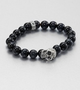 A striking skull pendant of sterling silver accents a stretch beaded bracelet of blue tigers' eye for the modern man of style.Sterling silverTigers' eyeWidth, about 10mmDiameter, about 3Made in USA