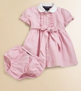 Sweet ruffles and a bow prettily accent the classic oxford shirtdress.Club collarShort puffed sleeves with single-buttonFront buttons with ruffle trimEmpire waist with a self-tie bowMatching bloomersCottonMachine washImported Please note: Number of buttons may vary depending on size ordered. 