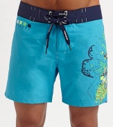 A slightly cropped swim style for every man, brightened with a contemporary floral graphic on the left leg. Lace-up waist Grip-tape back pocket Mesh lining Inseam, about 7 70% cotton/30% polyamide Machine wash Imported 