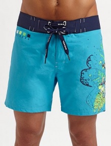 A slightly cropped swim style for every man, brightened with a contemporary floral graphic on the left leg. Lace-up waist Grip-tape back pocket Mesh lining Inseam, about 7 70% cotton/30% polyamide Machine wash Imported 