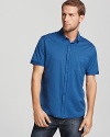 HUGO riffs on the classic polo, adding a button front and round hem.