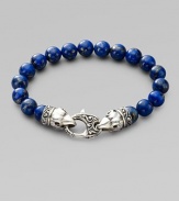 A welcome touch of color, strung with 10mm lapis beads and a raven's head sterling silver clasp. About 9¼ long Imported