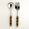 This stylish serving set combines amber and ruby glass handles with exquisitely hand-polished metal.