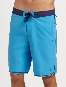 A modern, knee-length swim favorite in quick-dry nylon with tonal trim and ventilating grommets. Drawstring waist Side slash, back patch pockets Mesh lining Inseam, about 9½ Polyester Machine wash Imported A modern, knee-length swim favorite in quick-dry nylon with tonal trim and ventilating grommets. Drawstring waist Side slash, back patch pockets Mesh lining Inseam, about 9½ Polyester Machine wash Imported