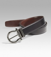 Smooth Italian calfskin has a signature Gancini buckle in polished gunmetal that detaches for switching strap from one color to the other. Approx. 1¼ wide Logo detail Made in Italy