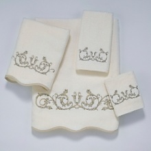 Luxurious sheared velour towel is embellished with a beautiful embroidered scroll motif. Finished with scalloped edge trimmed in coordinating gold. Luxurious sheared velour towel is embellished with a beautiful embroidered scroll motif. Finished with scalloped edge trimmed in coordinating gold.