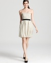 Origami-like pleats at the skirt lend dimension to this frothy Vera Wang Lavender Label strapless dress, finished with a contrasting ribbon belt for polish.