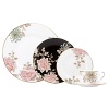 Painted Camellia brings vintage florals to life with just the right amount of color to make the dinner table unique. Draped against a gold-rimmed white canvas, delicate painted florals create a beautiful melodic feel. The salad plate, defined by a rich black background, is artfully juxtaposed to its white-bodied counterpart for a dramatic contrast.