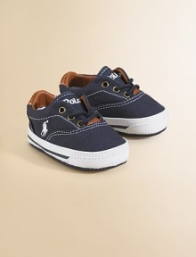 A classic pair of canvas sneakers for your little one with leather trim and padded insole.Lace-up closureCanvas upperCotton liningCanvas solePadded insoleImported