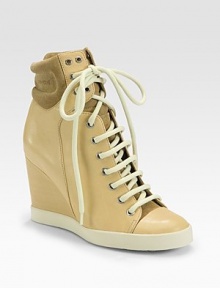 Leather and suede style with a lace-up front and covered wedge. Self-covered wedge, 3¼ (80mm)Leather and suede upperLace-up frontLeather liningRubber solePadded insoleMade in ItalyOUR FIT MODEL RECOMMENDS ordering one size up as this style runs small. Leather and suede style with a lace-up front and covered wedge. Self-covered wedge, 3¼ (80mm)Leather and suede upperLace-up frontLeather liningRubber solePadded insoleMade in ItalyOUR FIT MODEL RECOMMENDS ordering one size up as this style runs small.