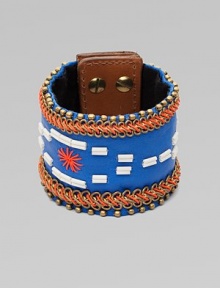 A wide cuff of bright leather, edged with golden beads and chains, stitched in colorful cord, with a center bugle-bead design.LeatherGoldtoneCotton backingLength, about 8½Width, about 2¾Stud snap closureImported A wide cuff of bright leather, edged with golden beads and chains, stitched in colorful cord, with a center bugle-bead design.LeatherGoldtoneCotton backingLength, about 8½Width, about 2¾Stud snap closureImported