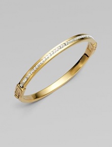 A narrow design that sparkles with a row of dazzling clear rhinestones. RhinestonesGoldtone steelDiameter, about 2¾Hinged, push lock closureImported A narrow design that sparkles with a row of dazzling clear rhinestones. RhinestonesGoldtone steelDiameter, about 2¾Hinged, push lock closureImported
