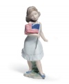 Get a little patriotic. An all-American girl clutches the flag in the delicately handcrafted Let Freedom Ring! porcelain figurine by Lladro.