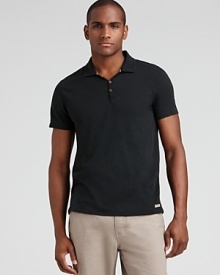 Slim fit polo with three button placket and logo tab at the hem.