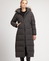 Designed for stylish warmth, natural coyote fur trims the removable hood of this full-length quilted coat.