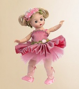 This fully-articulated Wendy doll has blue eyes and side-parted ivory hair styled into looped pigtails and decorated with a pink butterfly headband that is embellished with pink ribbon and white pearls. Her tutu of pink metallic organza over salmon colored charmeuse features a pleated skirt and pink tulle underskirt. The bodice of Butterfly Ballerina's dress is accented by a pink, green, and tan flower trim at the neckline and two trims at the waist.