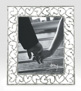 Finding inspiration from the imagery that floats around classic storytelling, this charming frame is crafted from hand-forged, nickel-plated metal by one of America's premier metalwork artists. From the Heart CollectionOverall, 11¾ X 14Accommodates a 8 X 10 photographArrives in a gift box for giving or storingImported 