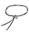 Stand out in silver tones. This stretch bracelet from Michael Kors is crafted from silver and gunmetal ion-plated mixed metal with glass fireball beads adding a bit of luster. Approximate diameter: 2-1/4 inches.