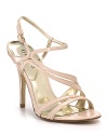 Asymmetrical patent leather straps create drama on these flattering slingbacks.