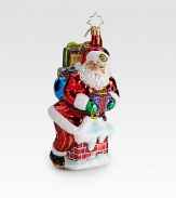 A traditional glass ornament shows Santa and gifts sneaking down the chimney.Hand-blownHand-painted6.5 tallMade in Poland