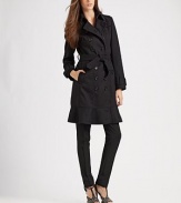 Classic trench details and a feminine, ruffled hemline dress up this cozy wool style.Fold-over collarDouble-breasted button frontBelted cuffsSelf beltSide slash pocketsRuffled hem80% wool/20% polyamideDry cleanImported