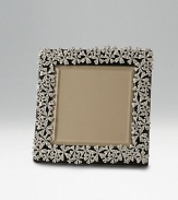 Polished and platinum-plated with ornate garland design. Leather back Arrives handsomely gift boxed