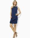 The classic shift dress is given a feminine update with an elegant draped front for romantic movement.