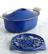 Update your setting with this instant classic. Perfect for oven to table presentation, this oval coquette and trivet duo is crafted from enameled cast iron in a striking hue that lights up your tabletop. From stir-fry to a slow-cooked casserole to a cake, this oval coquette distributes heat evenly and the secure lid traps in moisture and heat for remarkable results that leave guests coming back for more. Lifetime warranty.