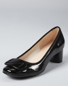 In glossy patent leather, these Ferragamo pumps get topped with a contemporary logo in tonal resin.