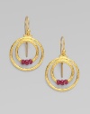 From the Glow Collection. Double hoops of 24K gold with triple ruby accents at the center.Ruby 24K yellow gold Length, about 1 Width, about ½ Ear hooks Imported 