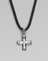 A handsomely crafted sterling silver cross pendant hangs from a finely braided leather necklace. Adjustable necklace, 18-20 Imported