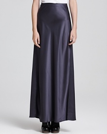 A flowing Vince maxi skirt flaunts a luxe metallic shine, creating an elegant evening look perfect for cocktails or a chic al fresco engagement. A flowing Vince maxi skirt flaunts a luxe metallic shine, creating an elegant evening look perfect for cocktails or a chic al fresco engagement.