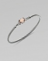 From the Petite Wheaton Collection. A faceted pillow of softly hued pink morganite, edged with diamonds and set on a classic sterling silver cable bangle.Diamonds, 0.08 tcwPink morganiteSterling silverDiameter, about 2½3mm cableHook claspImported