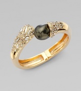 A striking black baroque-shaped shell pearl dramatically caps one end of a Swarovski crystal-laden bangle with a gleaming golden finish.CrystalShell pearl18k goldplatedDiameter, about 2¼Width, about ½Hinged with magnetic claspMade in USA