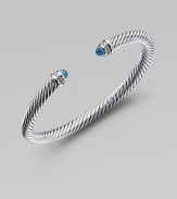 From the Color Classic Collection. A signature Yurman cable of sterling silver, richly enhanced by bands of pavé diamonds encircling blue topaz end caps. Diamonds, .09 tcw Blue topaz Sterling silver Width, 5mm Diameter, about 2½ Made in USA