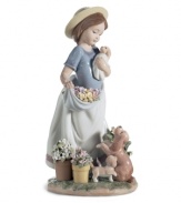 The picture of happiness. Lladro's A Romp in the Garden figurine features cute puppies, spring flowers and the sweet woman who takes care of them all in delicately glazed porcelain.