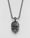 Eye-catching rubies and black diamonds embellish this edgy skull design of sterling silver, suspended from a link chain.Sterling silver/titaniumBlack diamond/rubyAbout 9 diam.Imported