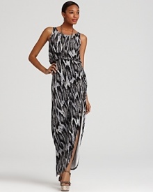 Opt for hyper-modern elegance in this floor-sweeping GUESS maxi dress, boasting a sultry snake print and thigh-high slit. Opt for hyper-modern elegance in this floor-sweeping GUESS maxi dress, boasting a sultry snake print and thigh-high slit.