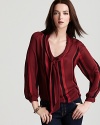 Pin-thin stripes and a luxe rouge hue bring a glamourous edge to the season's silk Tucker blouse. Pair it with your favorite skinnies for effortless chic.