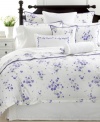 With ruffled edges and embroidered blooms in pure white cotton, the Trousseau Violets neckroll pillow from Martha Stewart Collection tops beds off with graceful garden style.